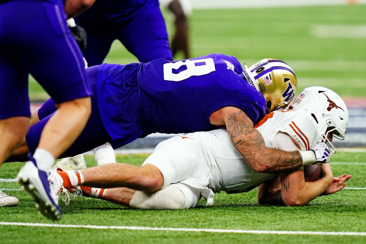 Jan 1, 2024; New Orleans, LA, USA; Washington Huskies defensive end Bralen Trice (8) sacks Texas Longhorns quarterback Quinn Ewers (3) during the fourth quarter in the 2024 Sugar Bowl college football playoff semifinal game at Caesars Superdome. Mandatory Credit: John David Mercer-USA TODAY Sports  